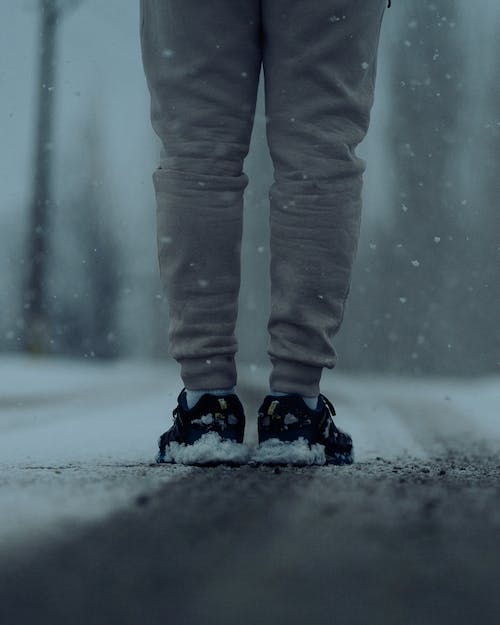 Free Person Standing on Snowy Road Stock Photo
