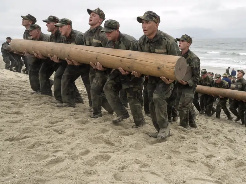Stephen Varanko III on Navy SEALs Gear | My Zeo Military training team carrying a large log during a beach exercise.