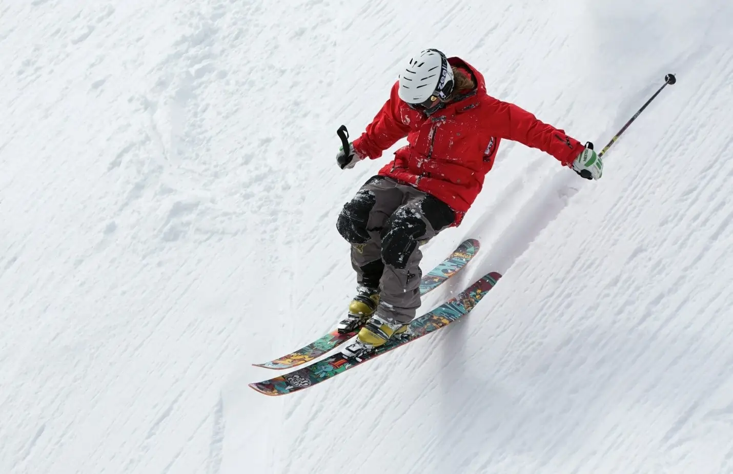Person skiing downhill on snowy terrain
